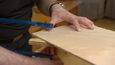 Man hands cut vintage soviet airplane model wing from veneer Video stock 126895708