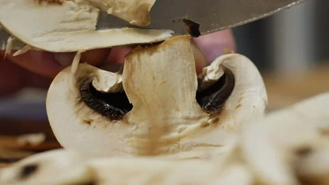 Man hands cutting champignons with a knife on kitchen table. The concept of Stock Footage 152349594