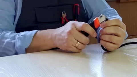 Man hands cutting electric wire with knife. Stock Footage 231145938