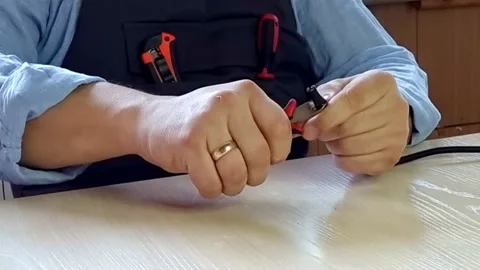 Man hands cutting electric wire with wire cutters. Stock Footage 231145956