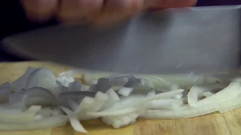 Man Hands Cutting Up Onion with Knife on Chopping Board Video stock 76521160