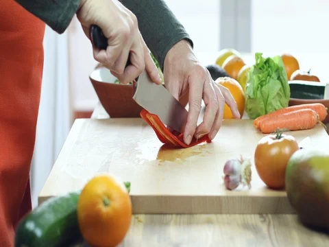Man hands cutting red pepper on wooden cutting board Stock Footage 73182572