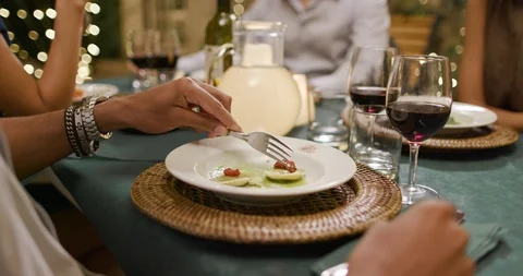 Man hands detail while eating using fork during a romantic gourmet dinner or 動画素材 109571001