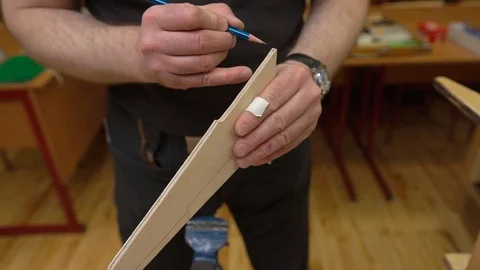 Man hands draw lines on brown outdated aircraft model wing Stock-Footage 127112612