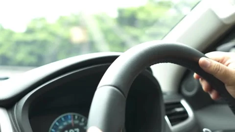 Man hands driver on steering wheel of a modern car on with street background. Stock-Footage 336268327