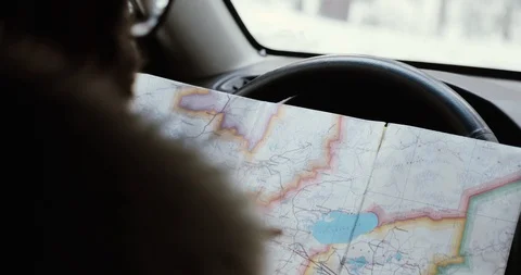 Man Hands Driving a Car, Looking for Directions in a Paper Map. Unrecognizable Stock Footage 101939271
