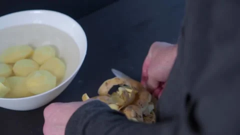 Man hands finish peeling pure potatoes Stock Footage 132287765