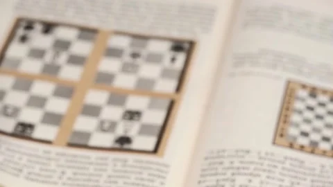 Man hands flips through blurry pages of book to study chess game. closeup. Stock Footage 255874058
