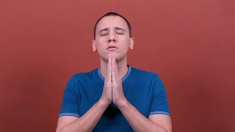 Man with hands folded in prayer, wait. man emotion isolated.  Stock Footage 123003103