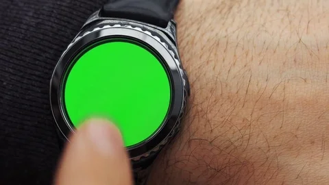 Man hands gestures on a round screen modern smartwatch with a green screen Stock Footage 85030035