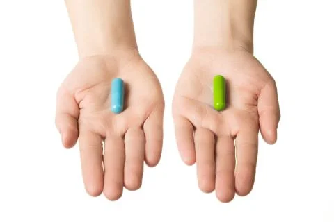 Man hands giving two big pills. Blue and green. Make your selection. calm n.. Stock Photos