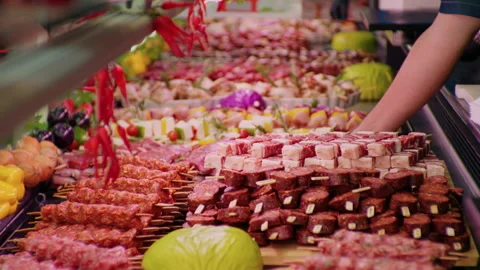 Man hands in gloves placing a tray full of pieces of meat on skewers. Stock Footage 295273235
