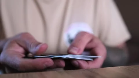 Man hands go through pile of bank cards and put them in stack, close up. Stock Footage 243582083