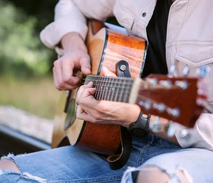 Man hands on the guitar strings close up image Stock Photos