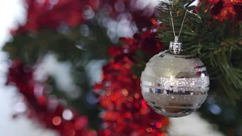 Man hands hanging a silver mirror reflective ball on Christmas tree. handsome Stock Footage 143254112
