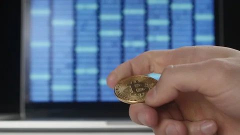 Man hands hold gold Bitcoin BTC on binary code background. mining and trading Stock Footage 86702163