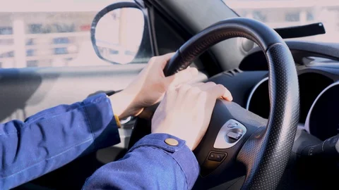 Man hands hold steering wheel of car on bright sunny day close up. Inside view. Stock Footage 128197815