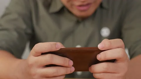Man hands holding and using smart phone to play online game. Leisure activity Video stock 141612561