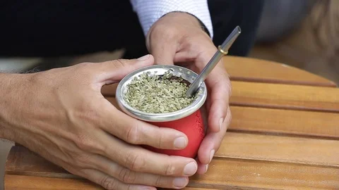 Man hands holding a calabash with hot yerba mate tea Stock Footage 127796515
