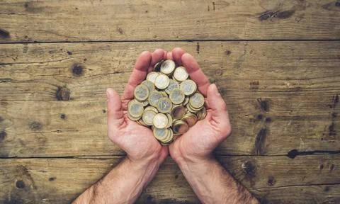 Man hands holding a stack of euro coins, top view, with copy space 写真素材