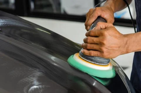 Man hands holding the work tool polish the car.Buffing and polishing car. Car Stock Photos