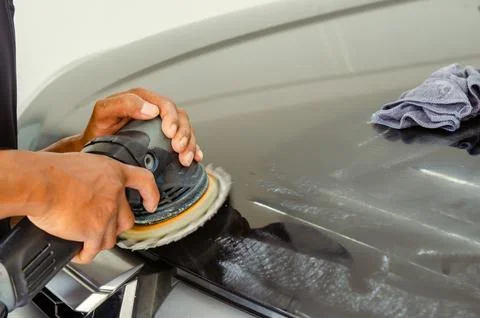 Man hands holding the work tool polish the car.Buffing and polishing car. Stock Photos