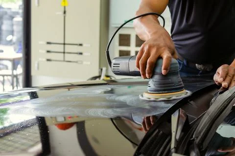 Man hands holding the work tool polish the car.Buffing and polishing car. Stock Photos