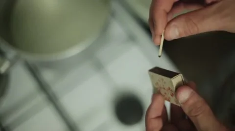 Man hands ignite match, hit on matchbox focus in. Ignition gas stove focus in Stock Footage 60374292
