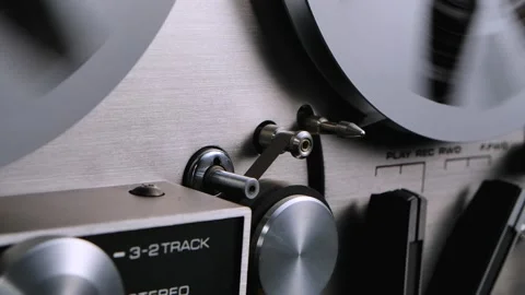 Man hands include rewind on vintage professional analog reel-to-reel audio Stock Footage 145829400