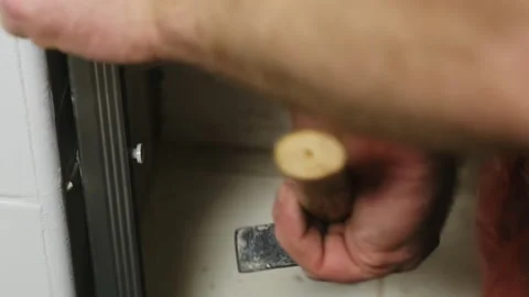 Man hands install nail into hole of metal plank using hammer Video stock 304404751
