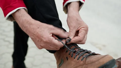 Man Hands Lacing Shoes On A Railing Stock Footage 275819479