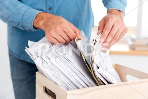 Man hands looking for documents in stack of folders Stock Photos