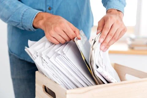 Man hands looking for documents in stack of folders 写真素材