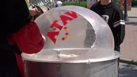 Man hands make fluffy sugar wool special machine. 4K Stock Footage 53606828