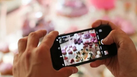 Man hands making photo of wedding stylish colorful candy bar in the restaurant Stock Footage