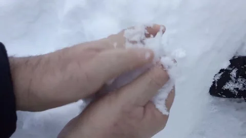 Man hands making snowball for playing in cold winter snowy day close up Stock Footage 297090125