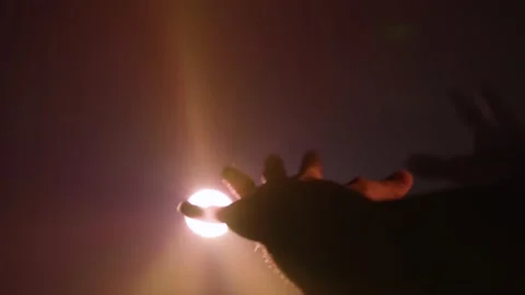 Man hands meet a colored and bright light Stock Footage 161414974