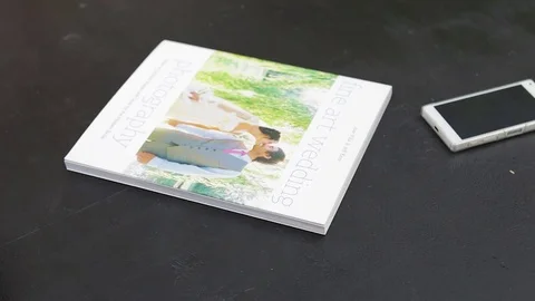 Man hands open a journal, flipping through pages, than close. Video stock 76969574