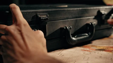 A man hands open a secret briefcase in a spy office Stock Footage 336236054