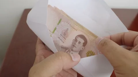 Man hands open white envelope with thousands Thai baht banknotes money. Stock Footage 238846239