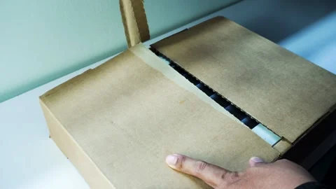 Man Hands Opening Box Revealing MacBook Pro 14 Inch in Space Black Stockbeeldmateriaal 334644906
