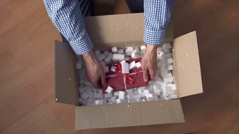 Man hands opening a parcel contains a gift Video stock 73521219