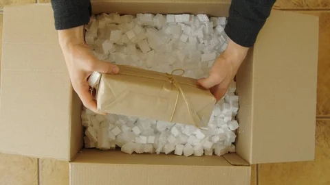 Man hands opening a parcel contains a gift. Unpacking box with another box. Stock Footage 110729973