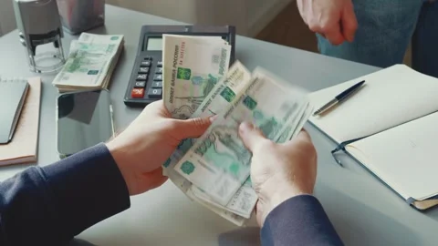 Man hands over cash in business transaction at office desk with calculator Stock Footage 299686341