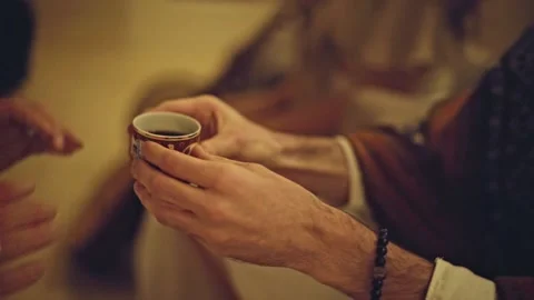 A man hands over a cup of elixir a ayahuasca ritual Stock Footage 231117322