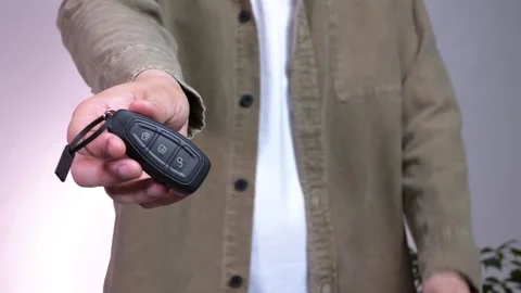 A man hands over the keys to a new car and makes a sign of approval Stock Footage 312282502