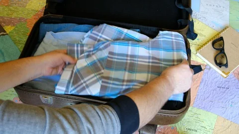 Man hands packs clothes Video stock 106355737