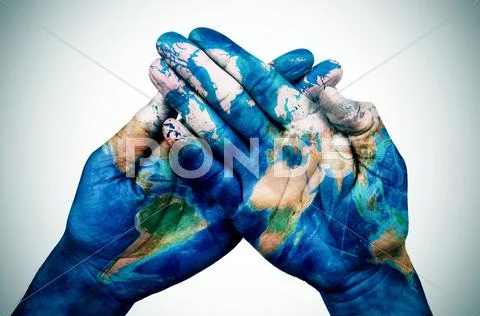 Man hands patterned with a world map (furnished by NASA) Stock Photos