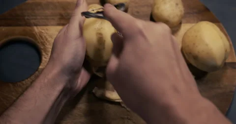 Man hands peel potatoes Stock Footage 261093966