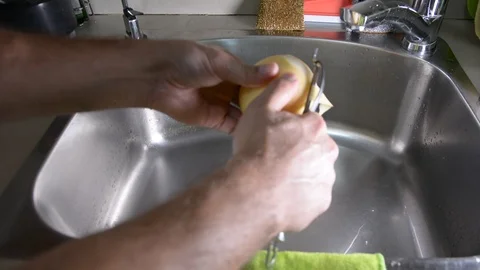 Man hands peeling fresh yellow pear 動画素材 95655591